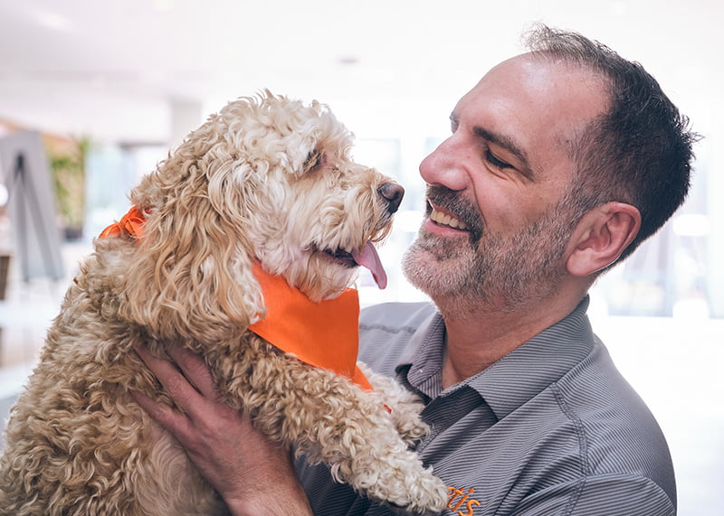 Zoetis corporate colleague holding small dog - Zoetis